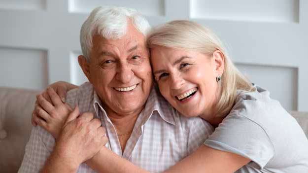Two happy and healthy seniors old people are smiling and looking at camera
